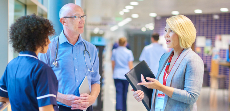 a healthcare solutions team talks with each other