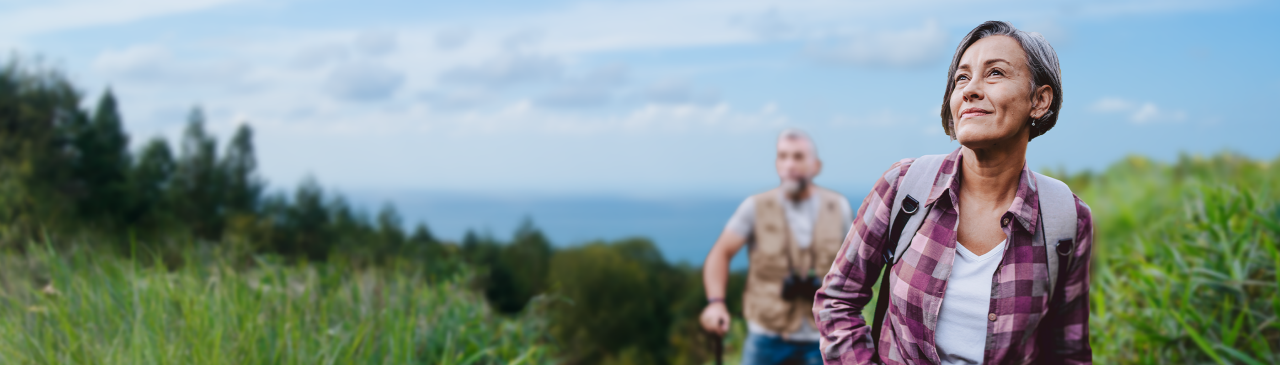 Smiling man climbing outdoors.
