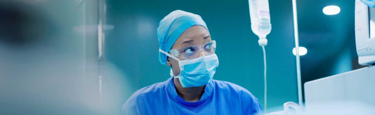Images of an implanter wearing mask in hospital.