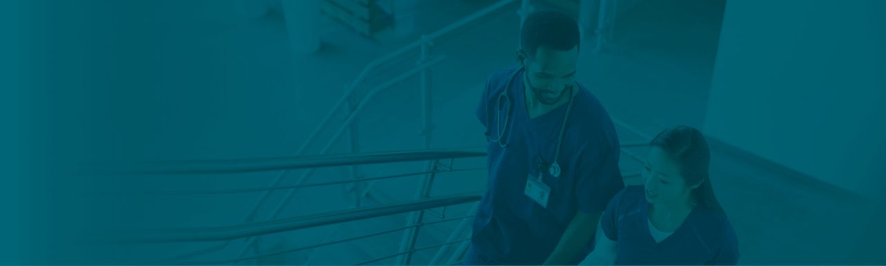Two healthcare professionals walking together on a faded blue background.