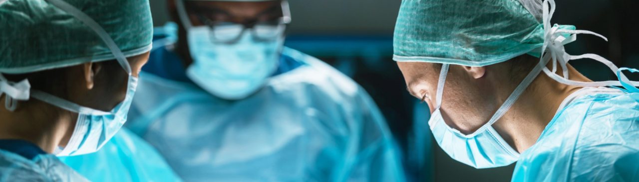 Doctors and hospital staff operating in gowns and masks