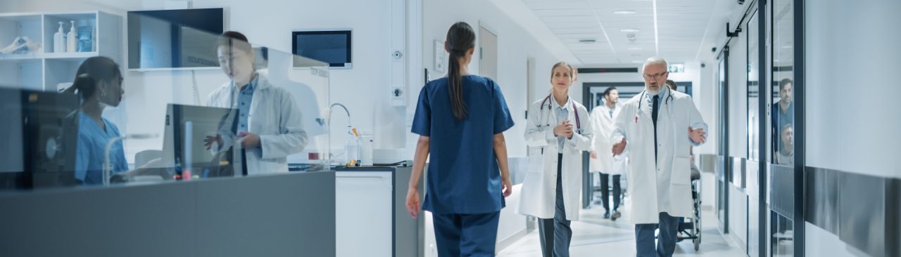 Doctors and hospital staff walking down a hallway.